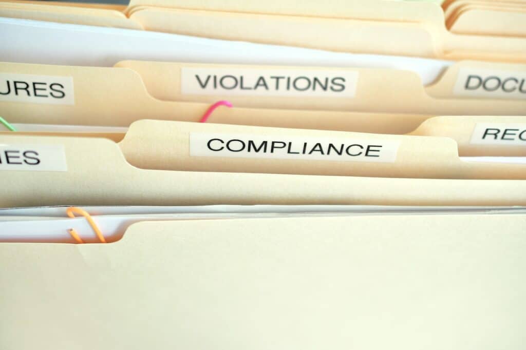 cyber insurance compliance folder labeled surrounded by other folders